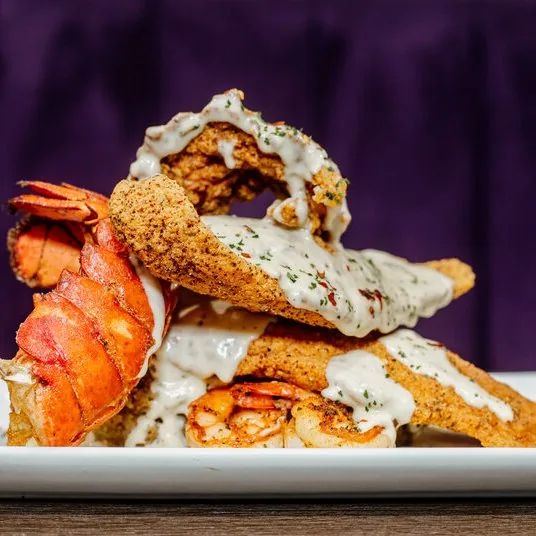 The Boss Seafood Stack at The Greasy Spoon, with fried catfish, lobster tail, and shrimp