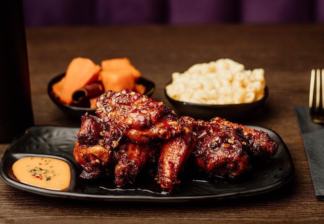 Smoky BBQ wing basket with candied yams and mac and cheese